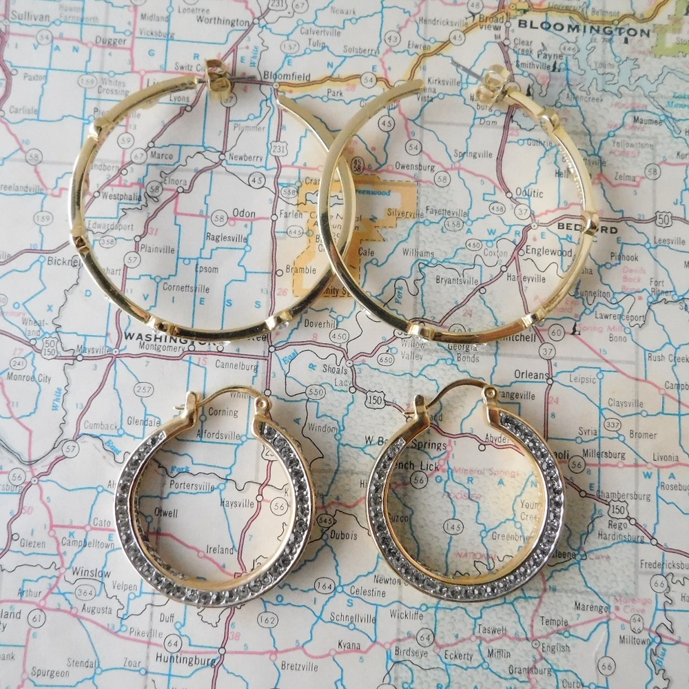 Two pairs of AKKAD gold toned hoop earrings